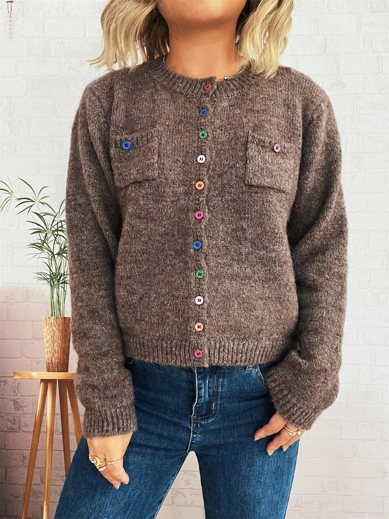 Brown knit cardigan with chest pocket, multicolor buttons down center, ribbed cuffs