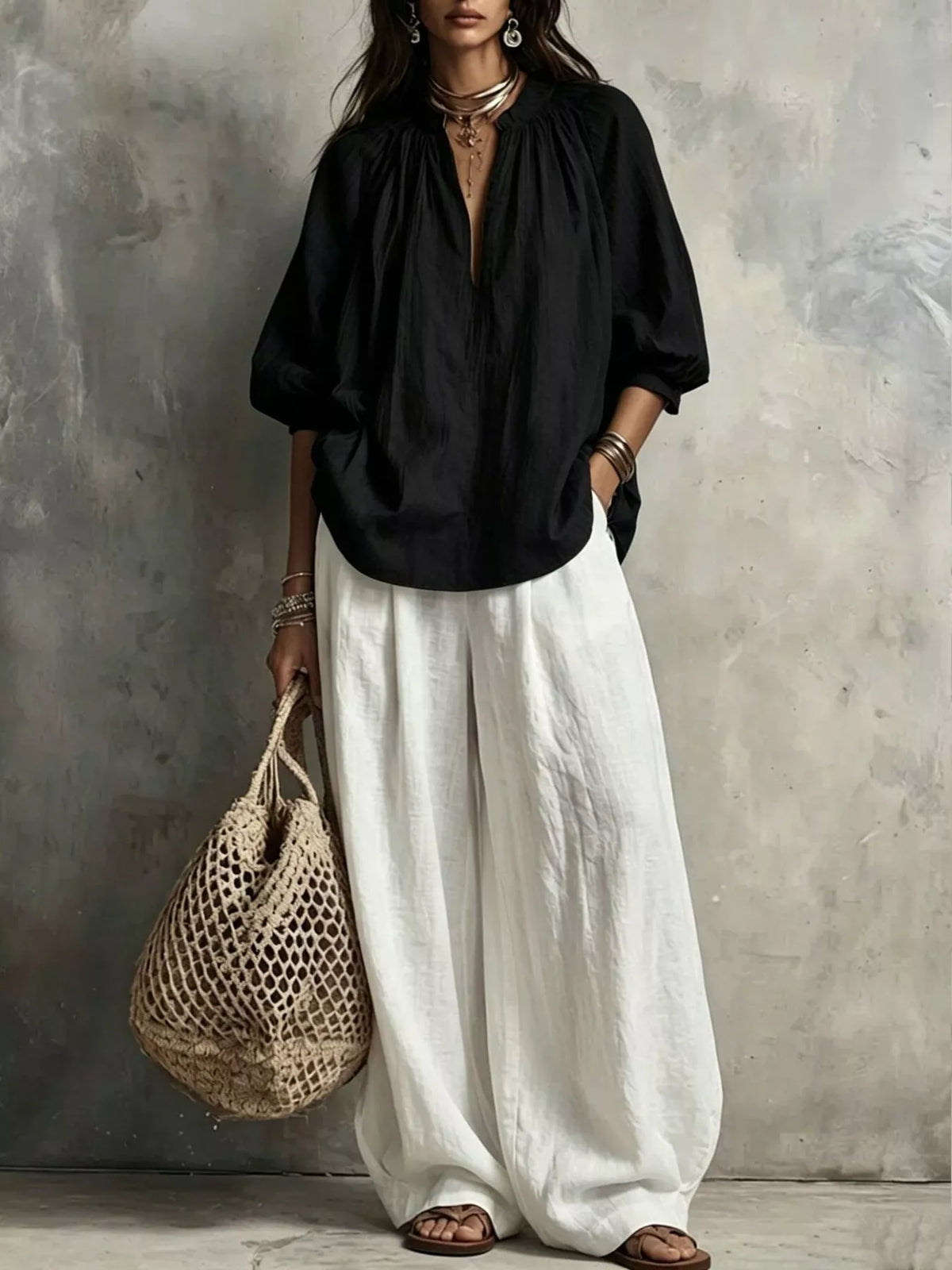 Black notched blouse and wide-leg pants set with balloon sleeves, paired with white trousers