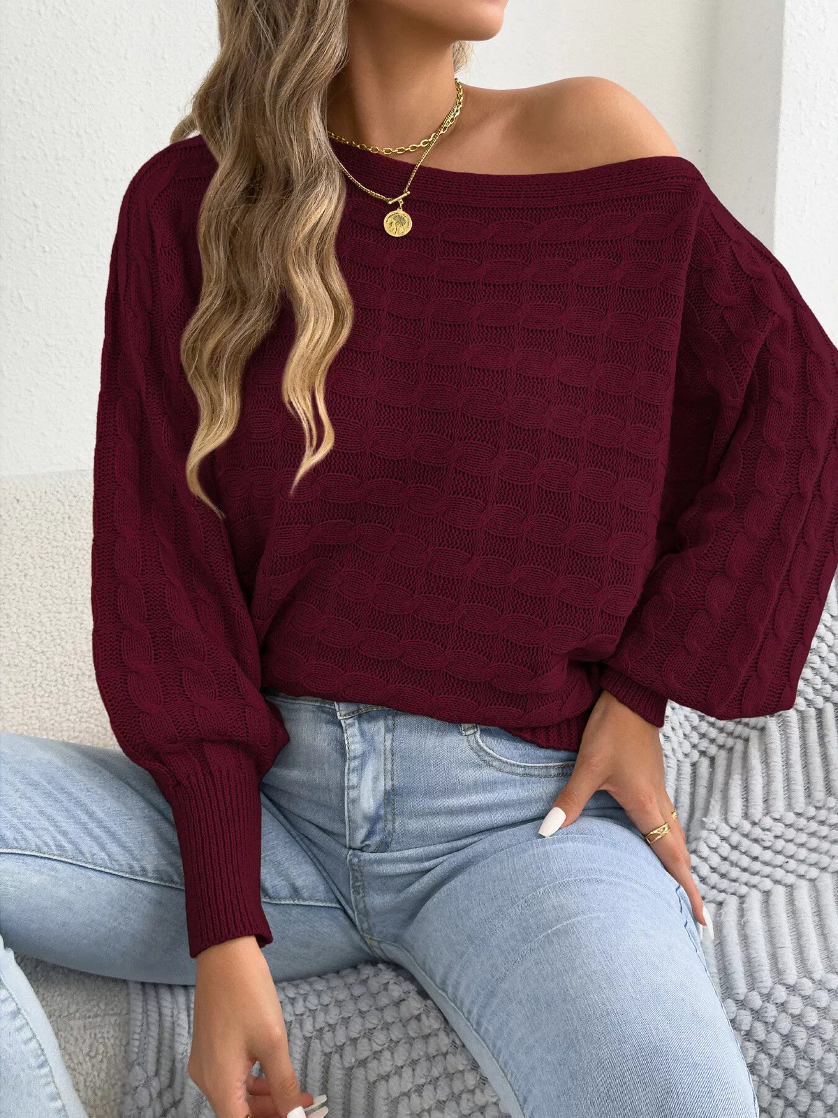 Burgundy cable knit boat-neck stretch sweater with textured stitch and ribbed cuffs