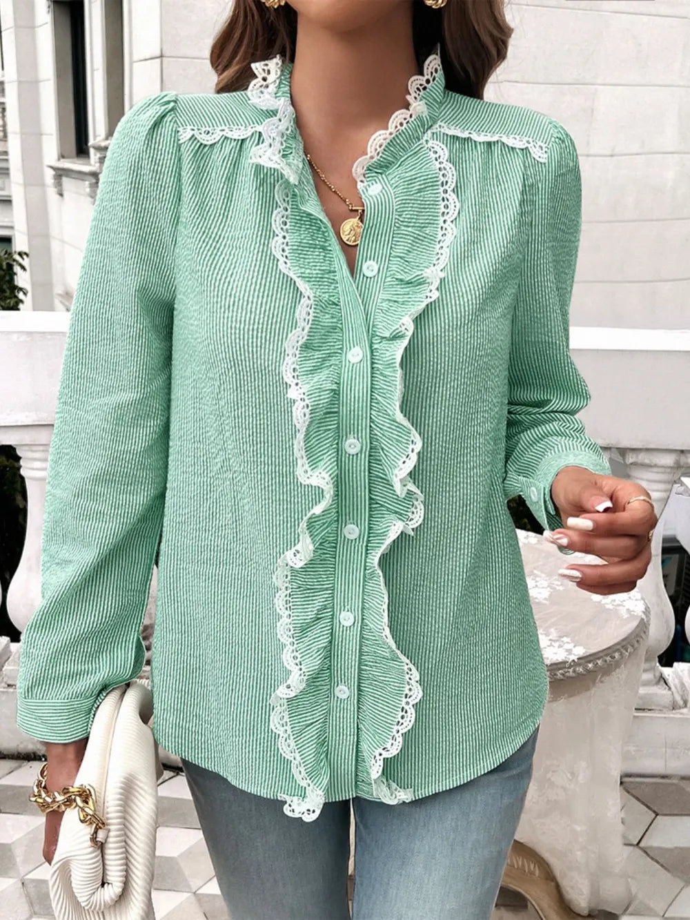 Green long-sleeve button shirt with white lace ruffle trim along the button placket