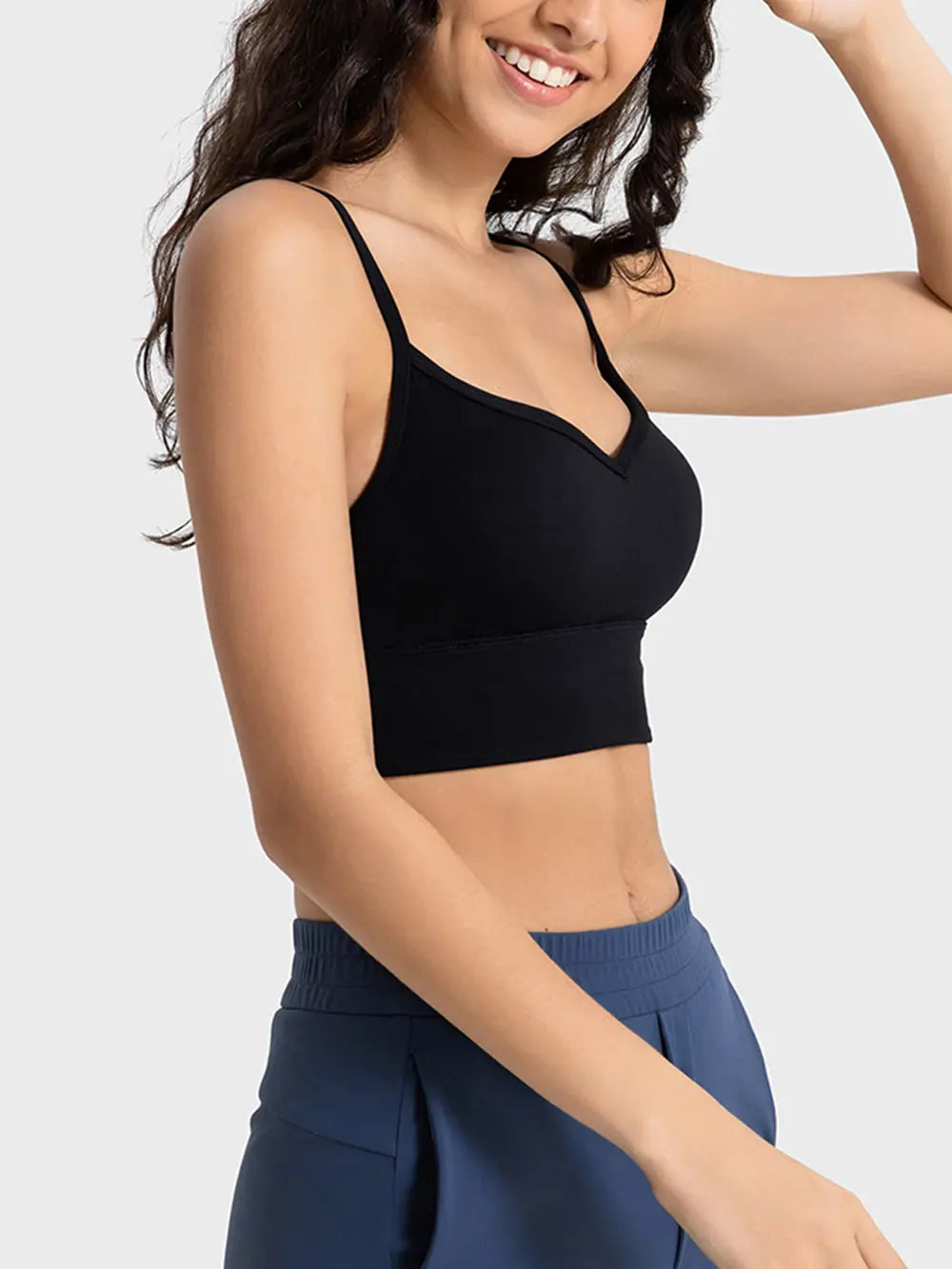 Black spaghetti strap sport bra with scoop neckline and fitted stretch fabric