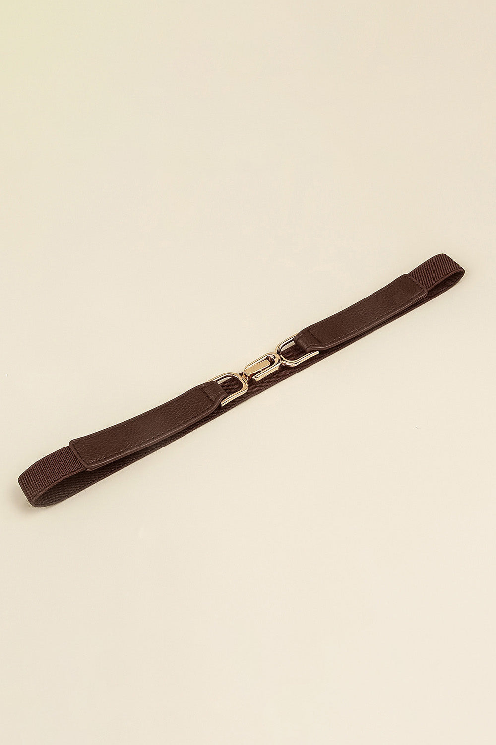 Elastic belt with dark brown buckle and stitched faux-leather strap
