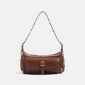 Caramel vegan leather shoulder bag with center buckle and gold-tone hardware, flap front