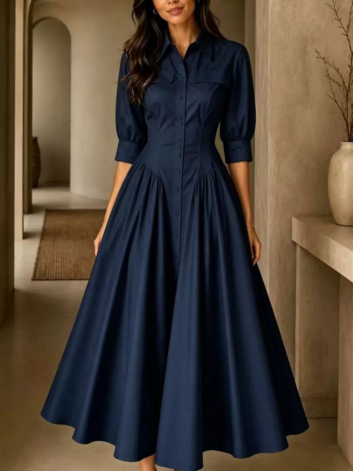 Dark navy button-down shirt dress with cinched waist, 3/4 puff sleeves, and gathered skirt.
