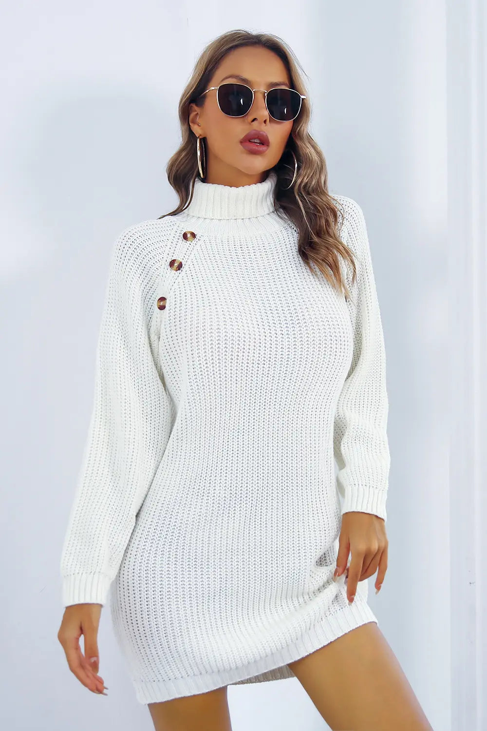 White knit turtleneck sweater dress with long sleeves and button placket at neckline