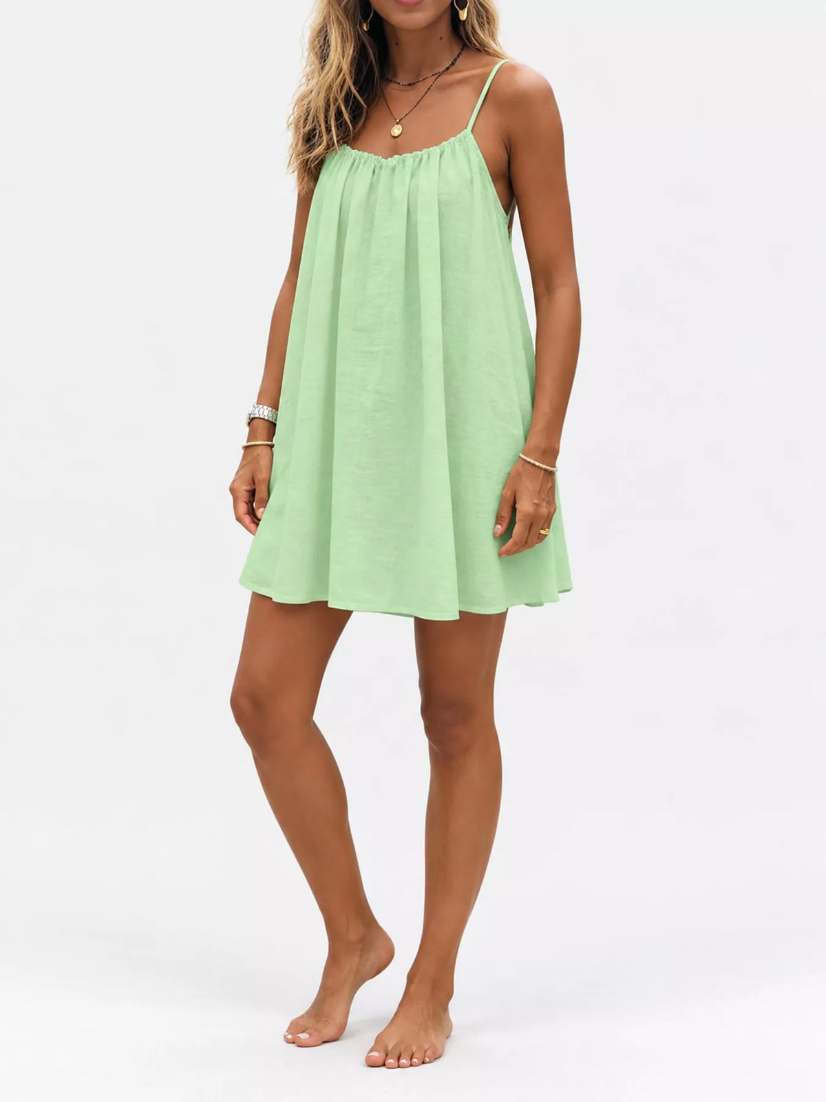 Mint green spaghetti-strap mini dress with ruched neckline and gathered swing skirt