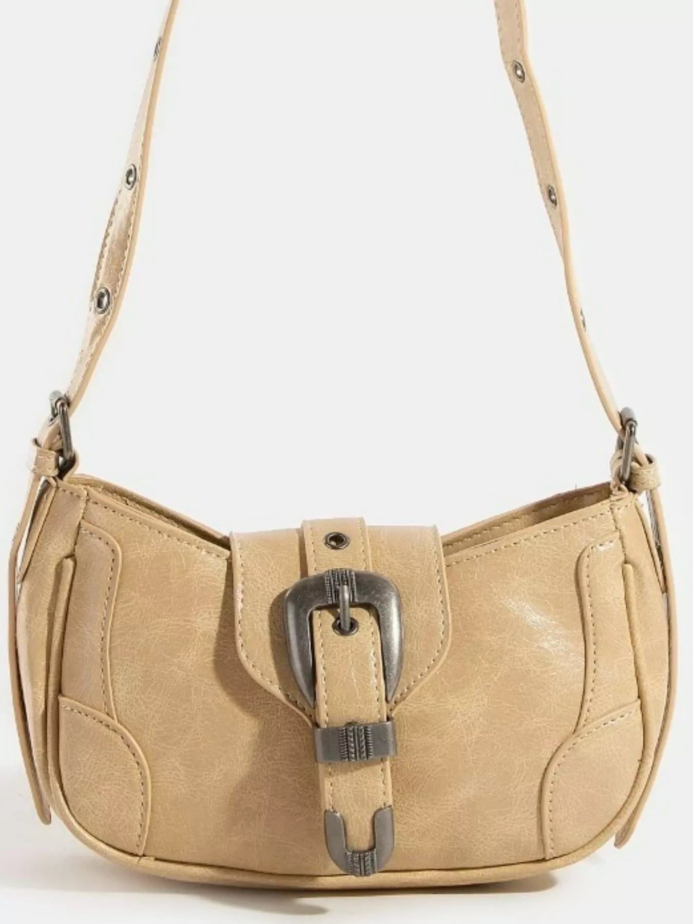 Tan curved hobo shoulder bag with front buckle accent and side panels.