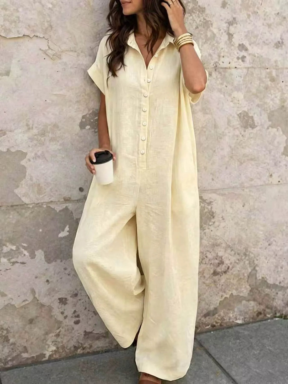 Cream button-front short-sleeve jumpsuit with wide legs and chest pockets