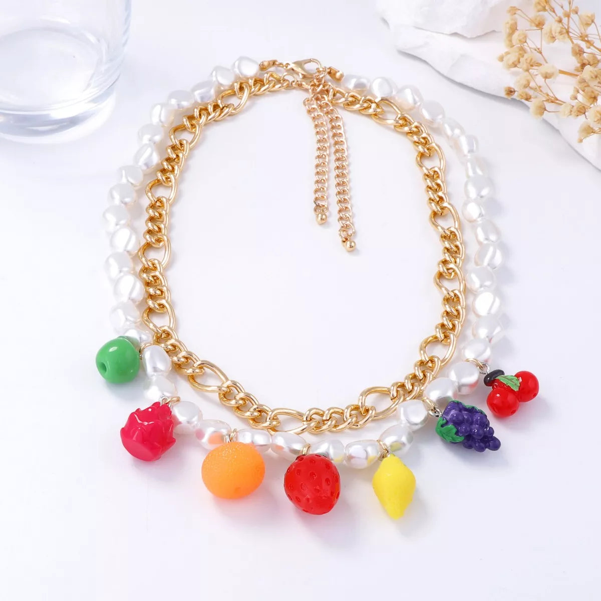 Double-layer charm necklace with gold chain and white pearls, dangling multi-color fruit charms