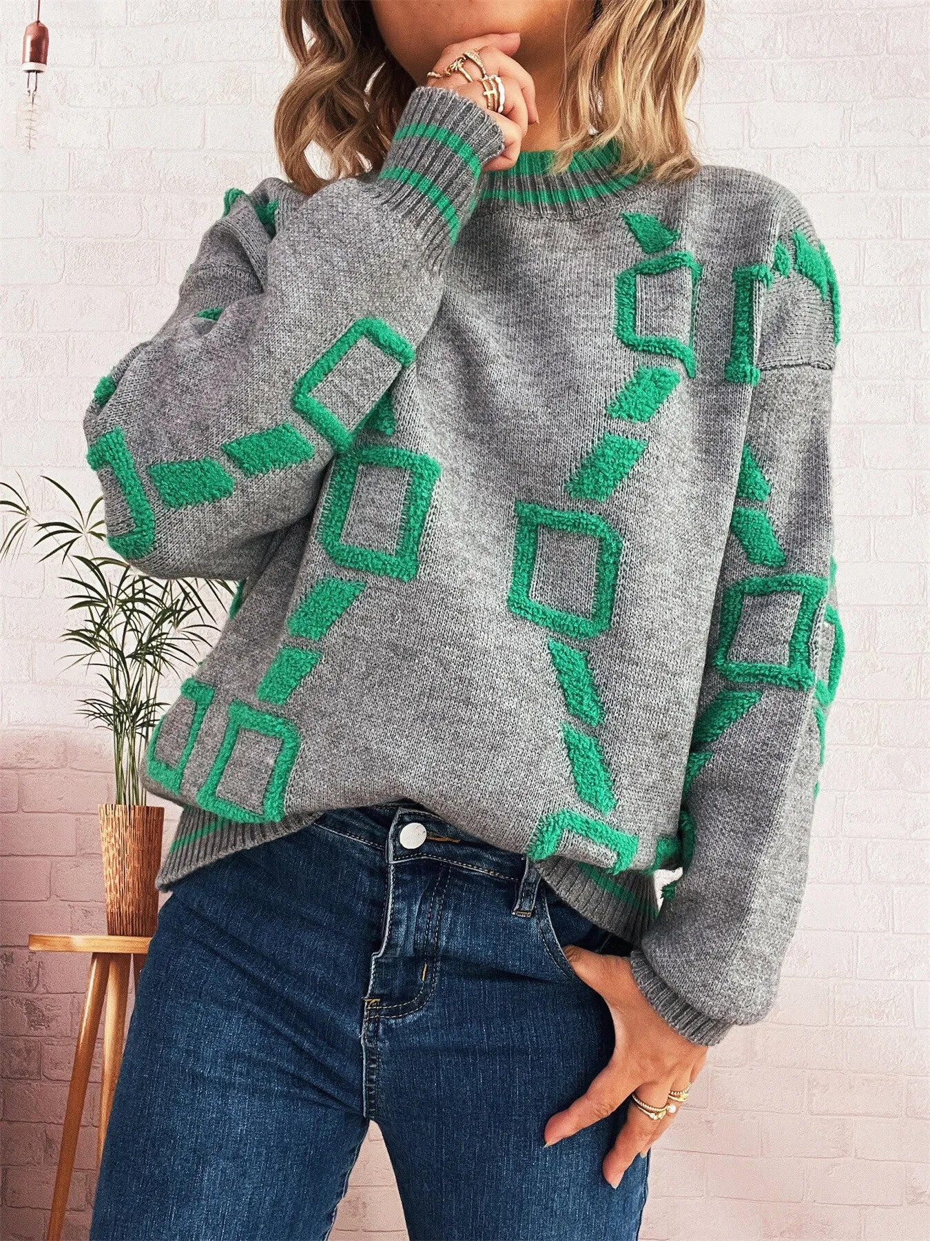 Grey long sleeve sweater with green geometric print, ribbed round neck