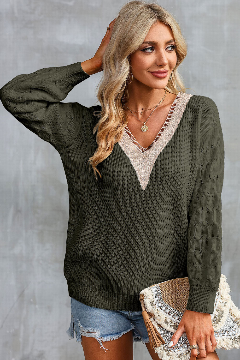 Army green V-neck sweater with cream contrast trim, long sleeves and cuff texture