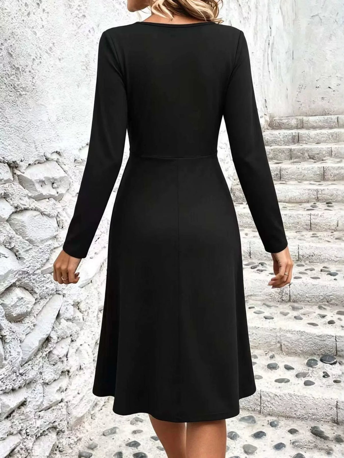 Black long-sleeve midi dress back view with flared skirt and waist seam