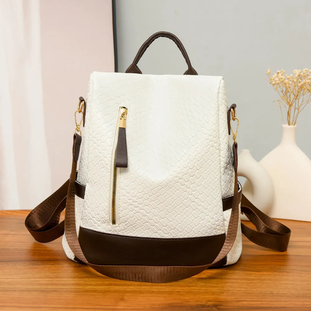 Vegan leather backpack bag in textured ivory with brown bottom, zip pocket and shoulder strap