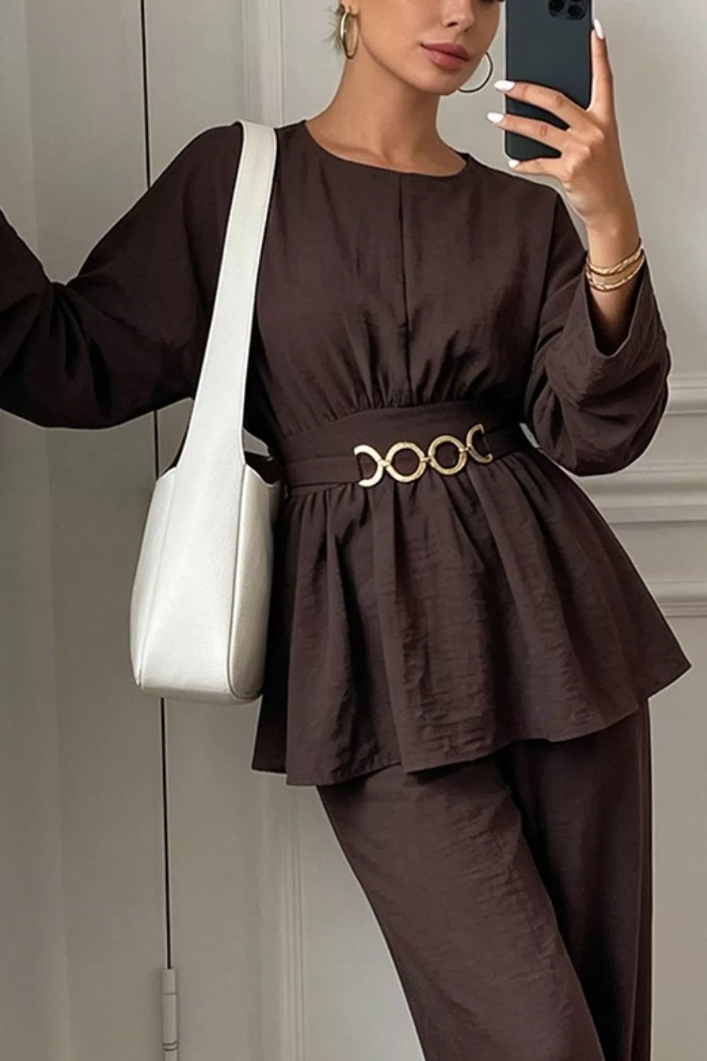 Dark brown peplum top and wide-leg pants set with metal ring waist detail.