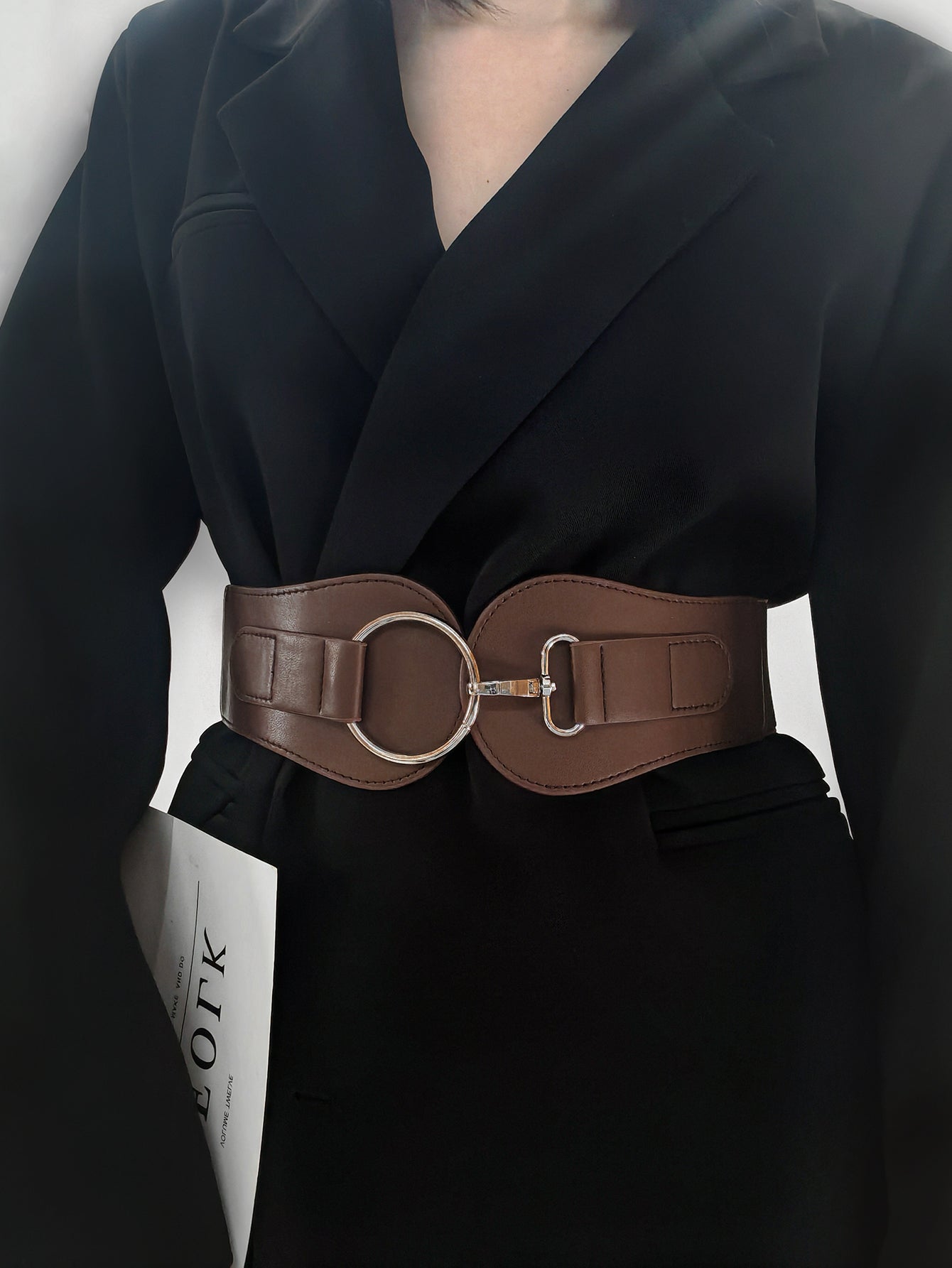 Caramel brown wide elastic belt with silver O-ring and buckle clasp on waist