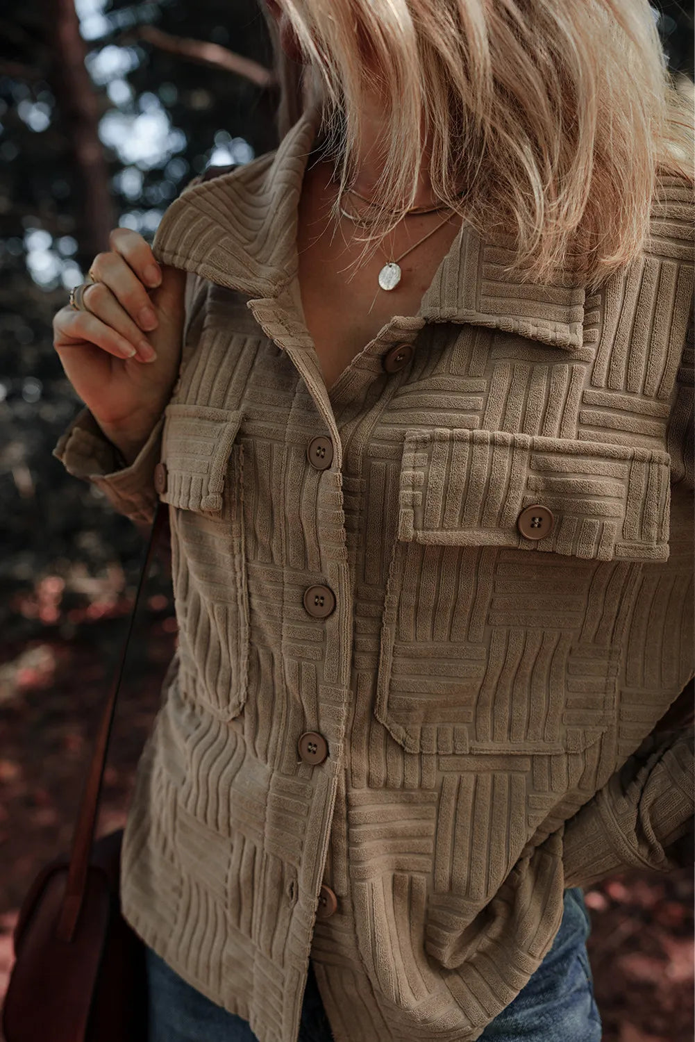 Taupe textured collared shacket with chest pockets and long sleeves, close-up