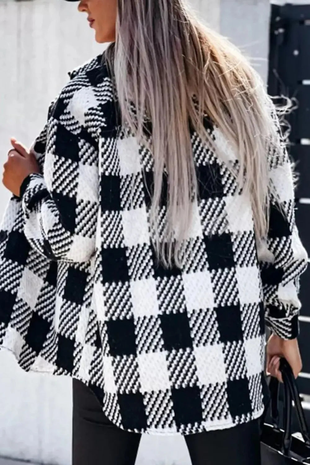 Black-and-white plaid button-up jacket with long sleeves and front buttons, side view