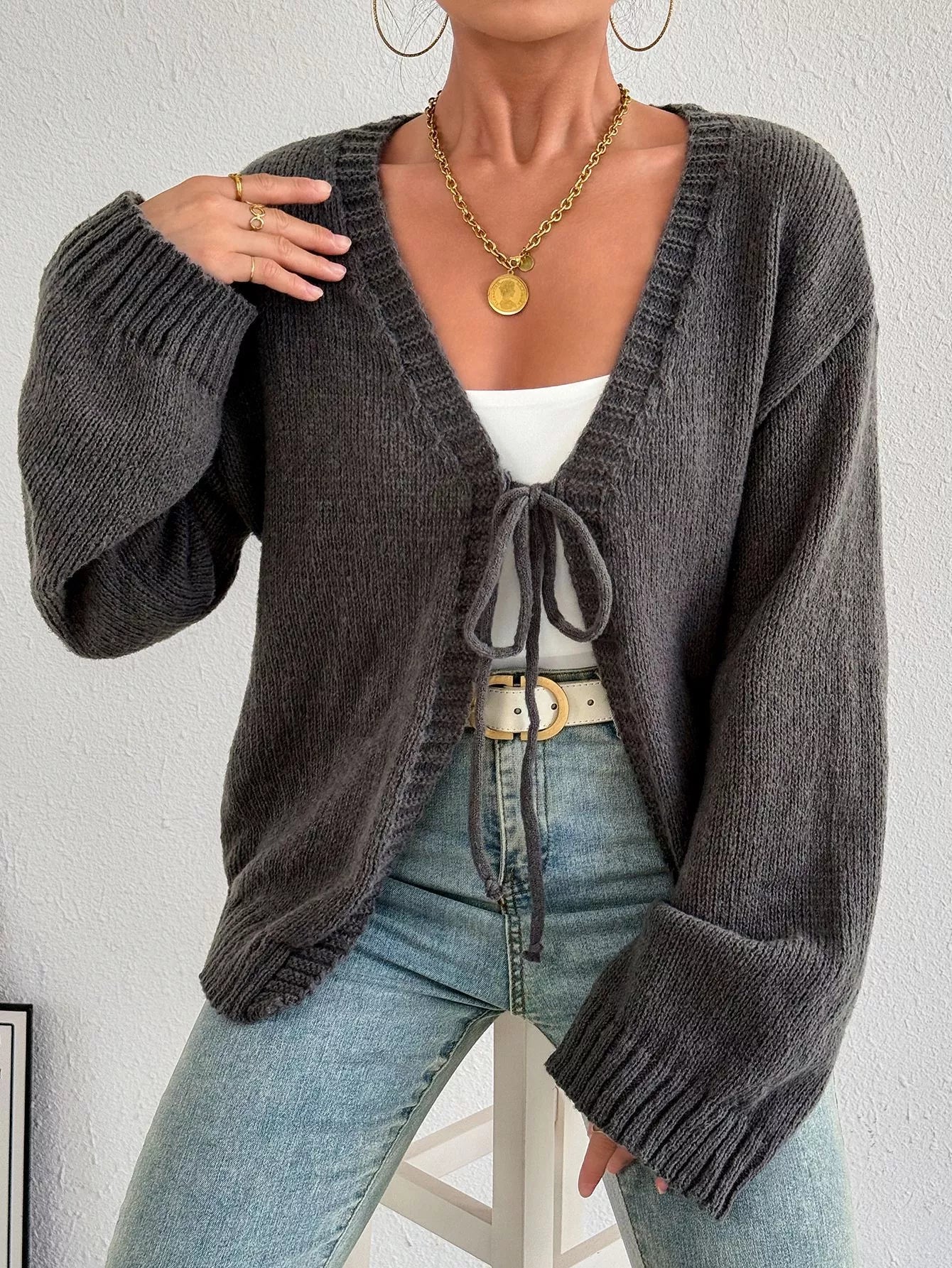 Dark gray tie-front cardigan with knot-tie neckline, long ribbed sleeves and relaxed fit