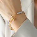 Gold-tone closure bracelet with chunky chain links and rhinestone bar detail