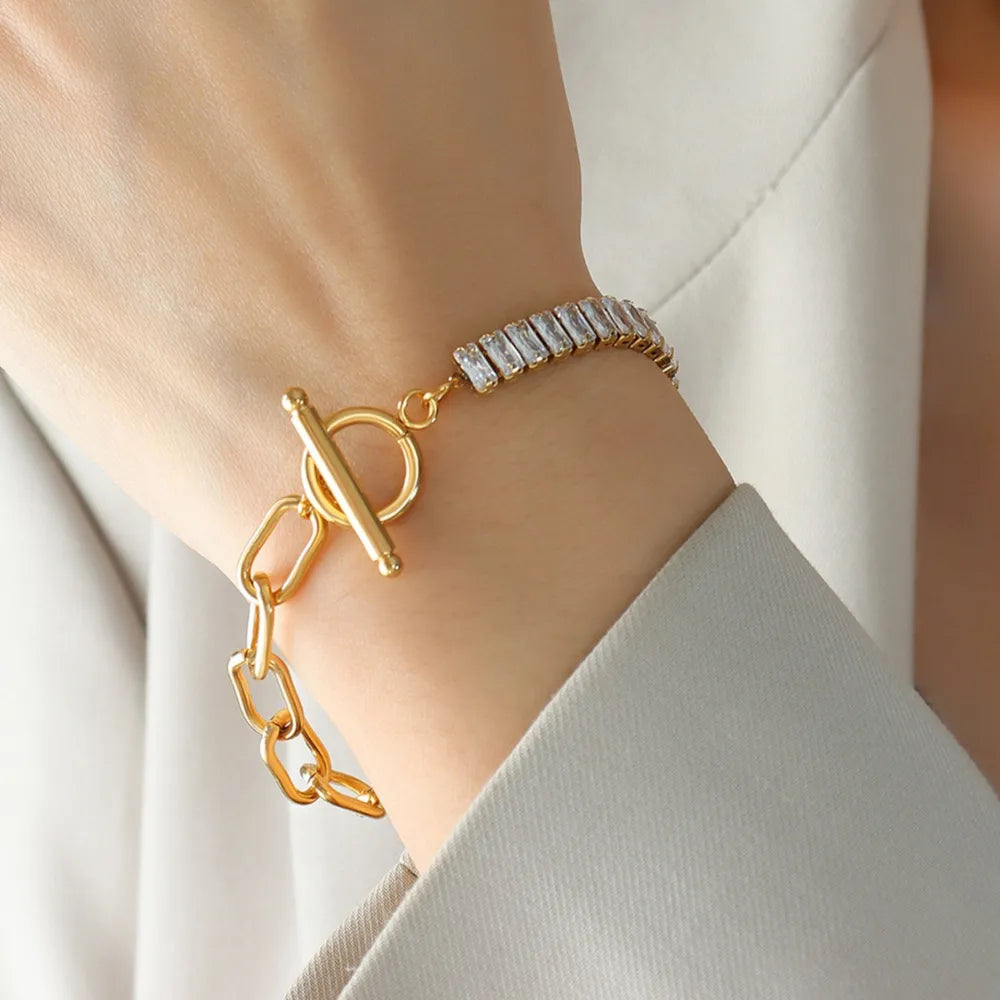 Gold-tone closure bracelet with chunky chain links and rhinestone bar detail