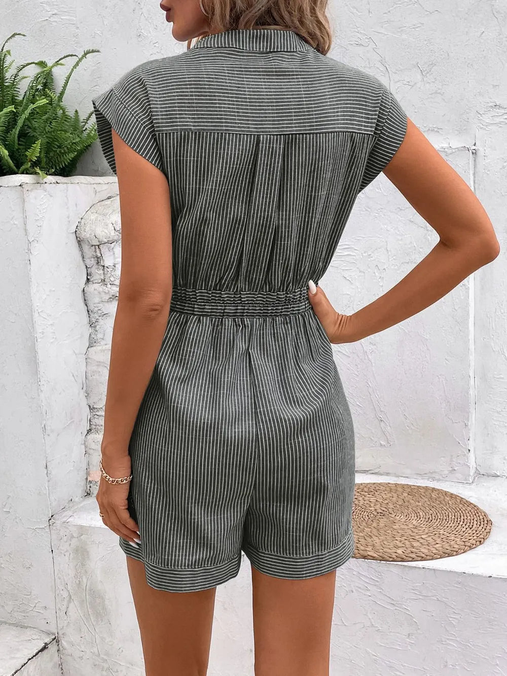 Striped notched tie-waist romper in green, back view with short legs and gathered waist