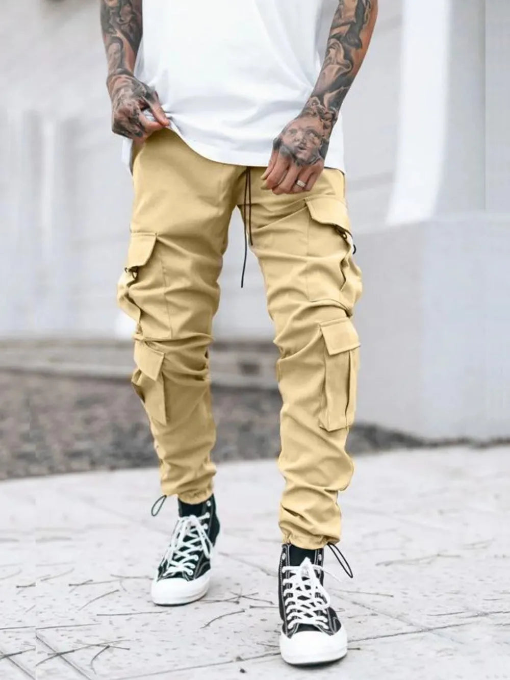 Men's tan drawstring cargo pants with side cargo pockets and ankle cuffs