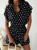Black polka dot button-up shirt with short sleeves and matching elastic-waist shorts