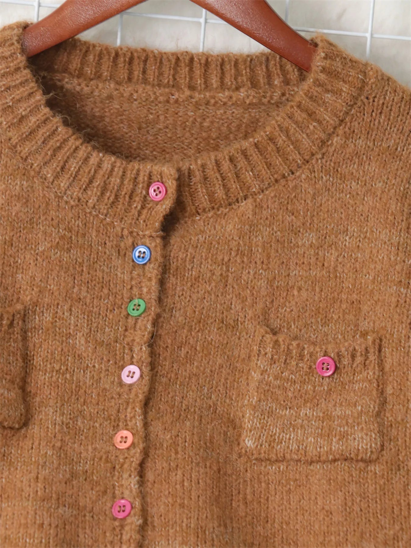 Brown cardigan neckline with ribbed trim and multicolor button placket details