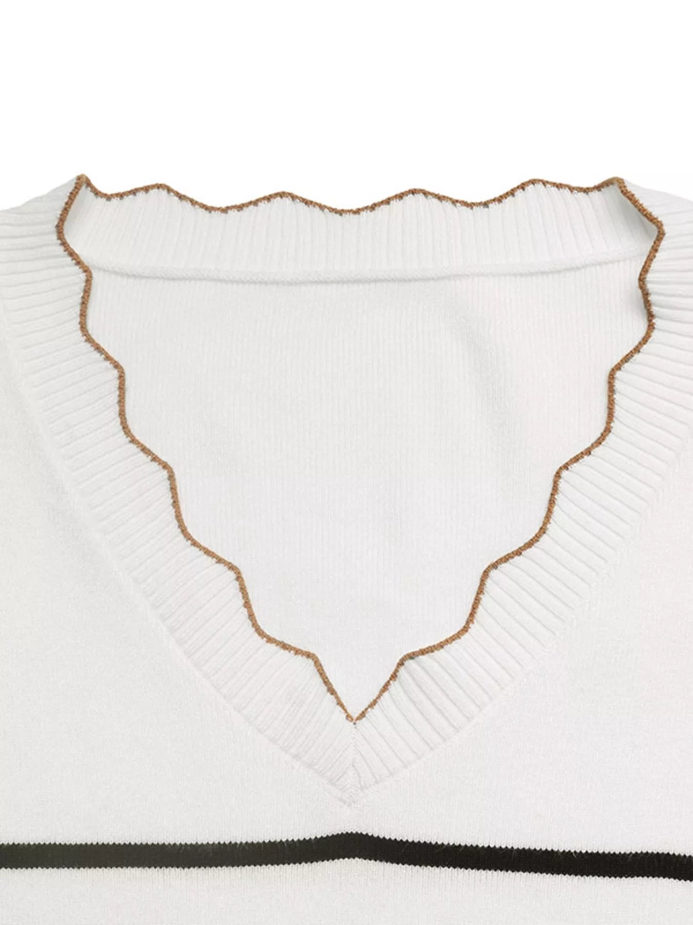 White ribbed V-neck sweater with scalloped edge trim and subtle knit texture