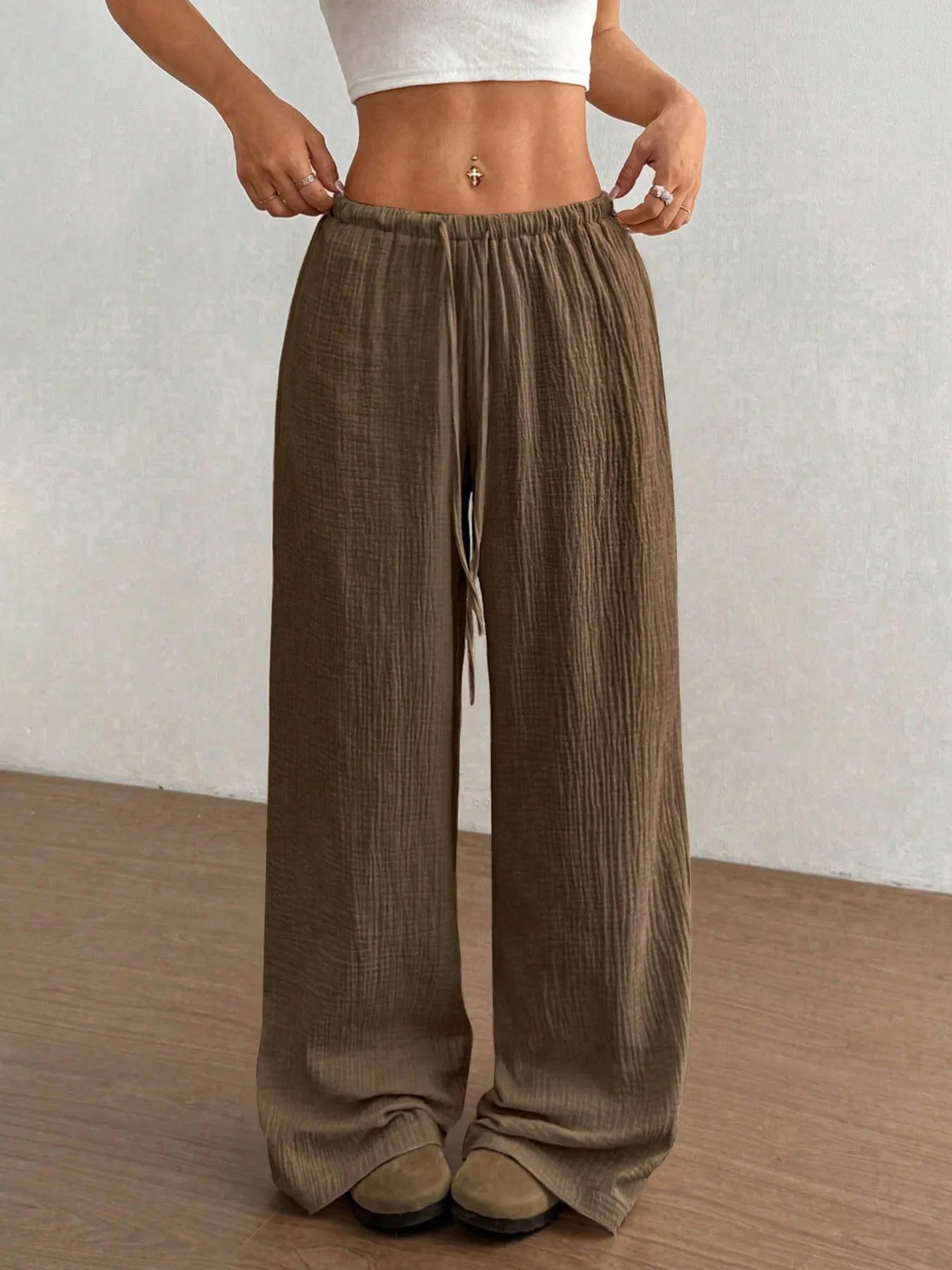 Khaki wide-leg drawstring pants with gathered elastic waistband and roomy legs