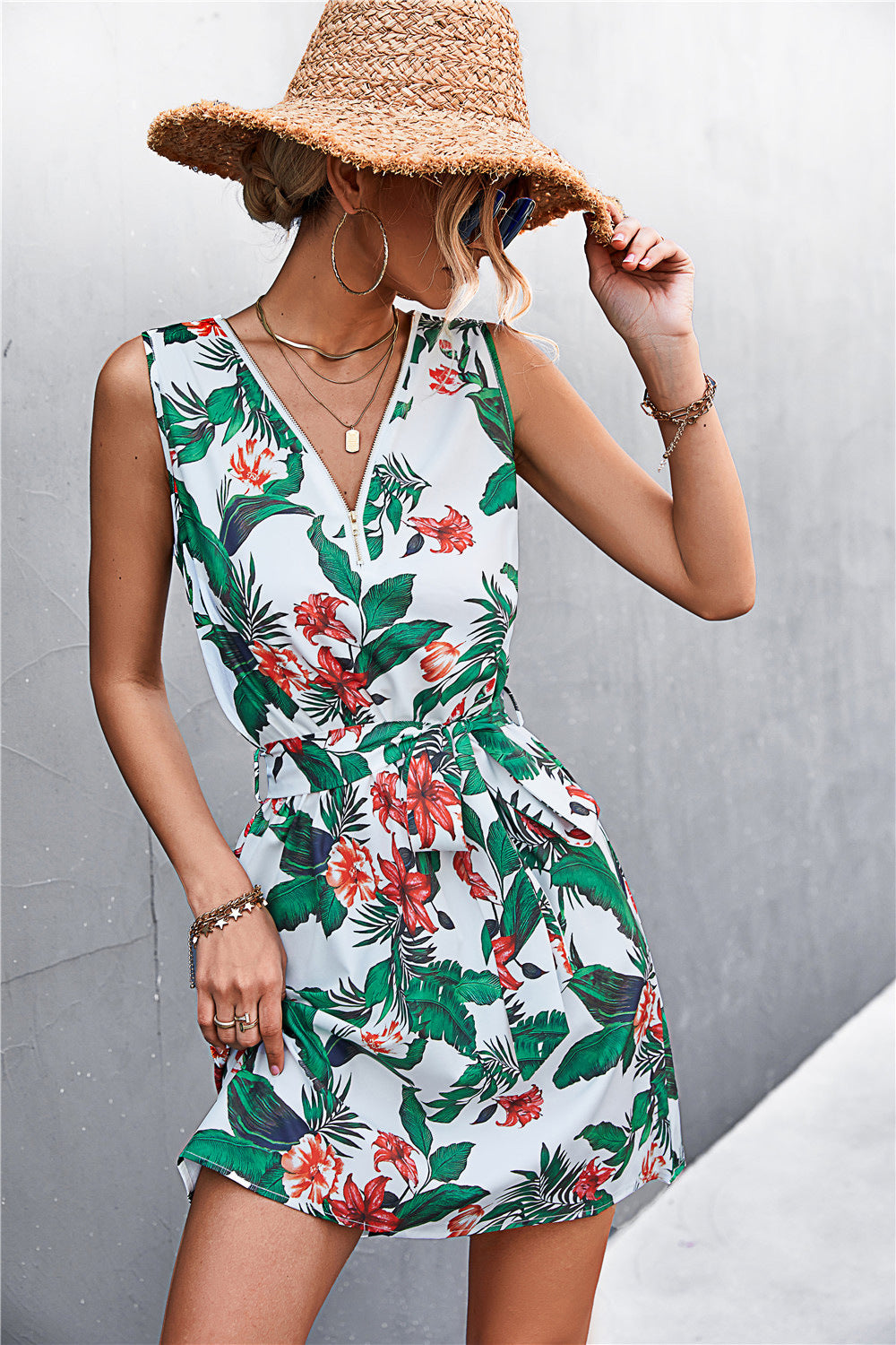 White sleeveless tropical floral dress with green and red print, belted waist, zip detail