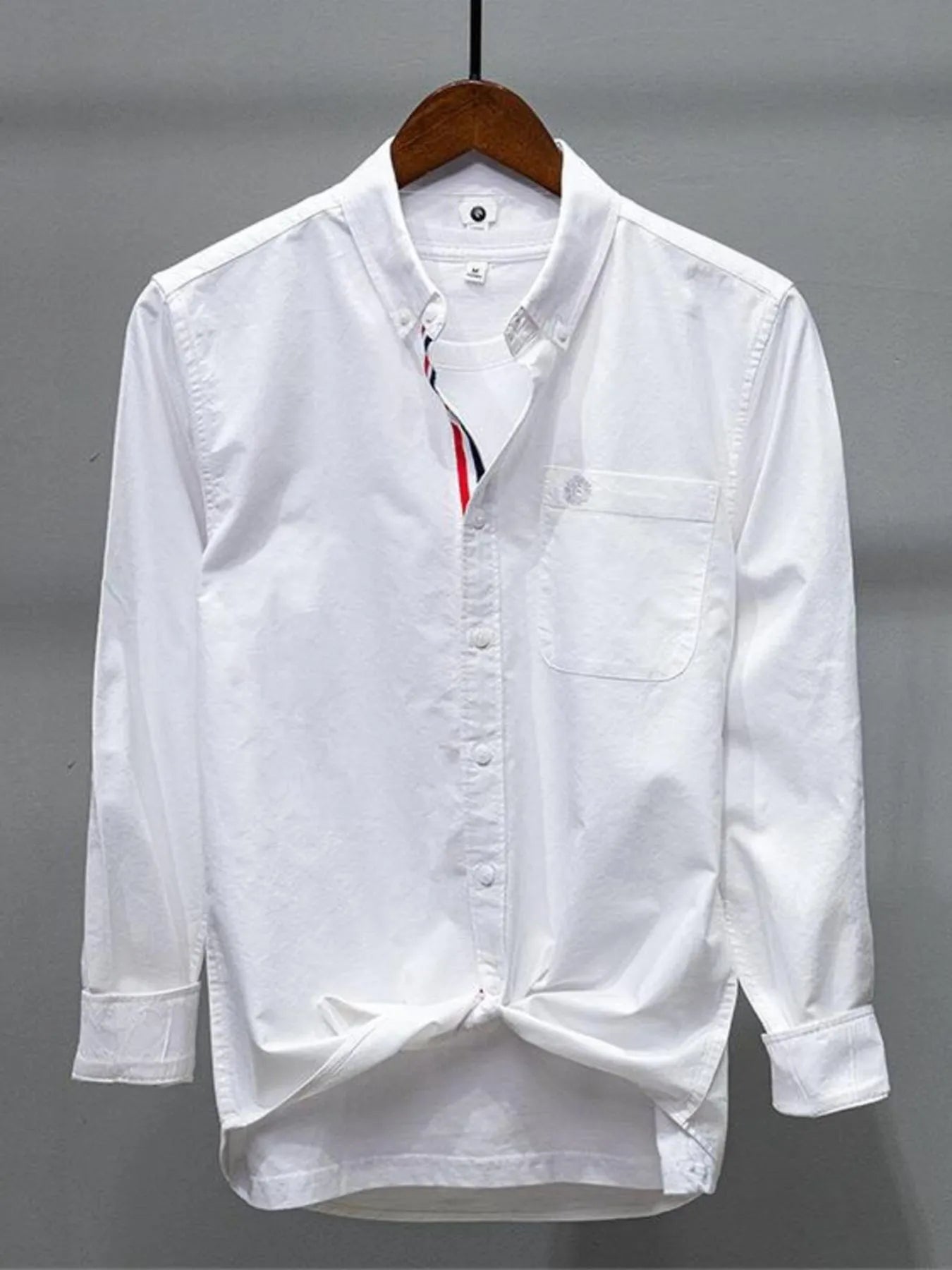 White button-up long-sleeve shirt with chest pocket and collar