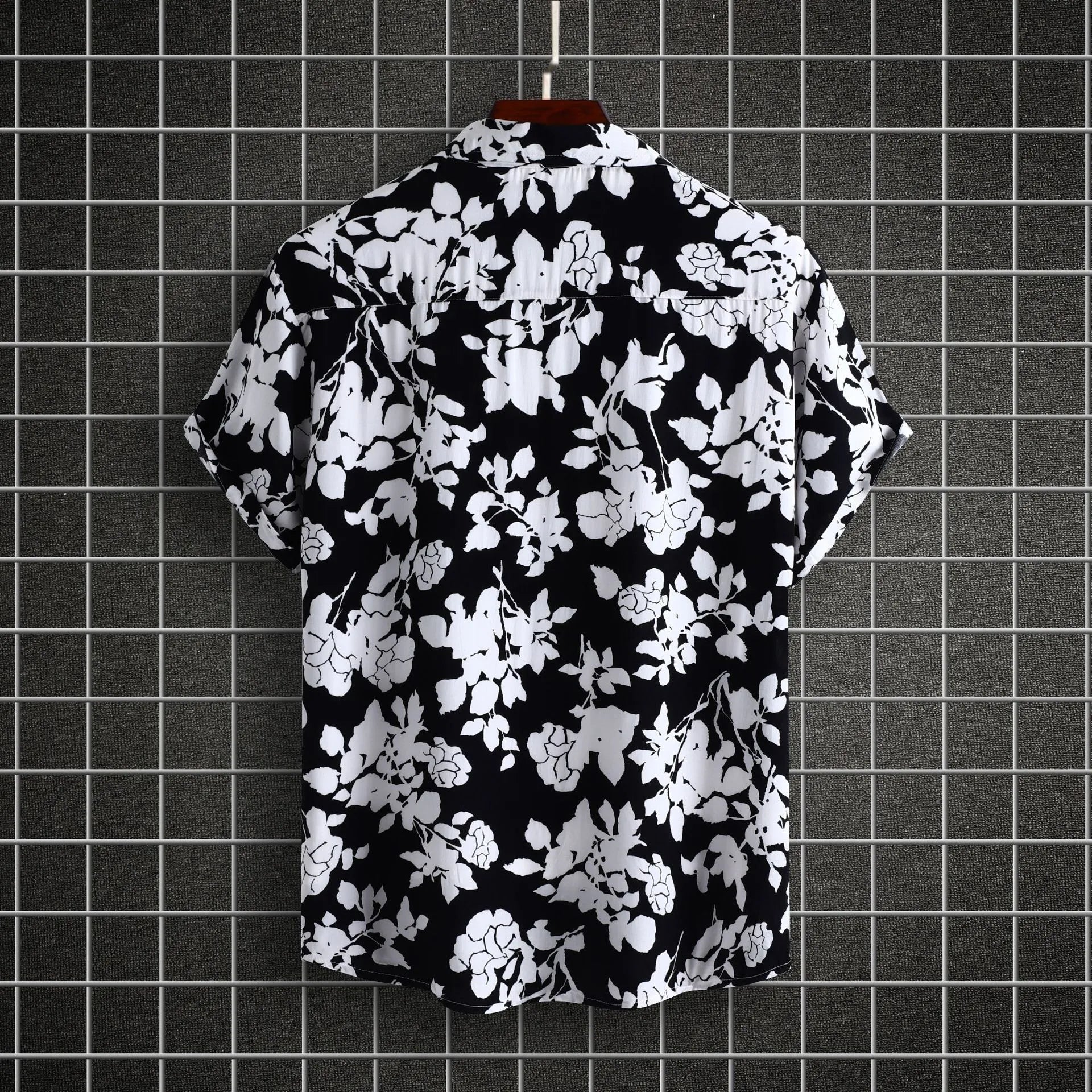 Back view of black short-sleeve casual shirt with white floral print