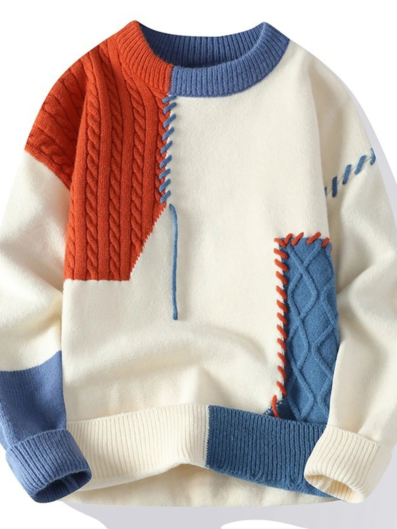 Color-block cable knit sweater, cream with orange cable panel and blue accents, ribbed cuffs
