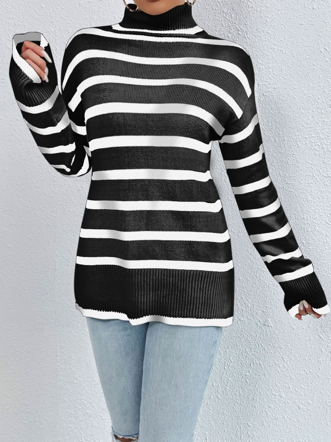 Black and white striped turtleneck sweater with ribbed collar, cuffs, and hem
