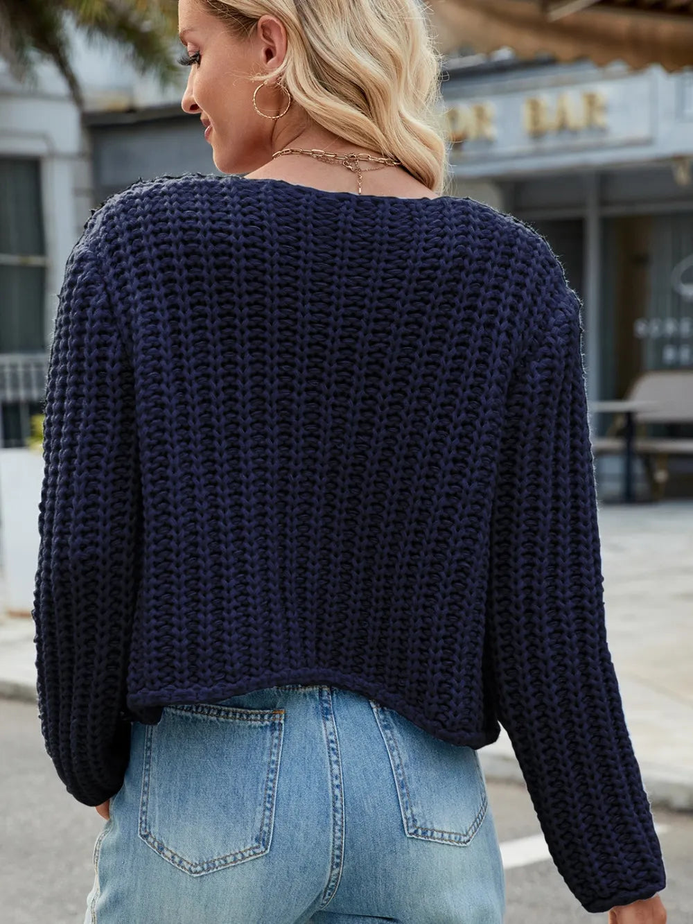 Dark navy chunky-knit button cardigan, back view with long sleeves