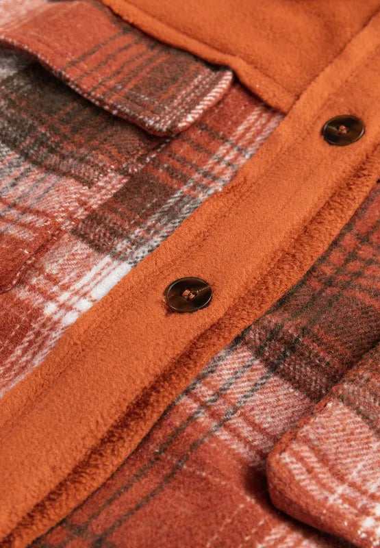 Plaid button-up long sleeve jacket front close-up with dark buttons and rust orange placket