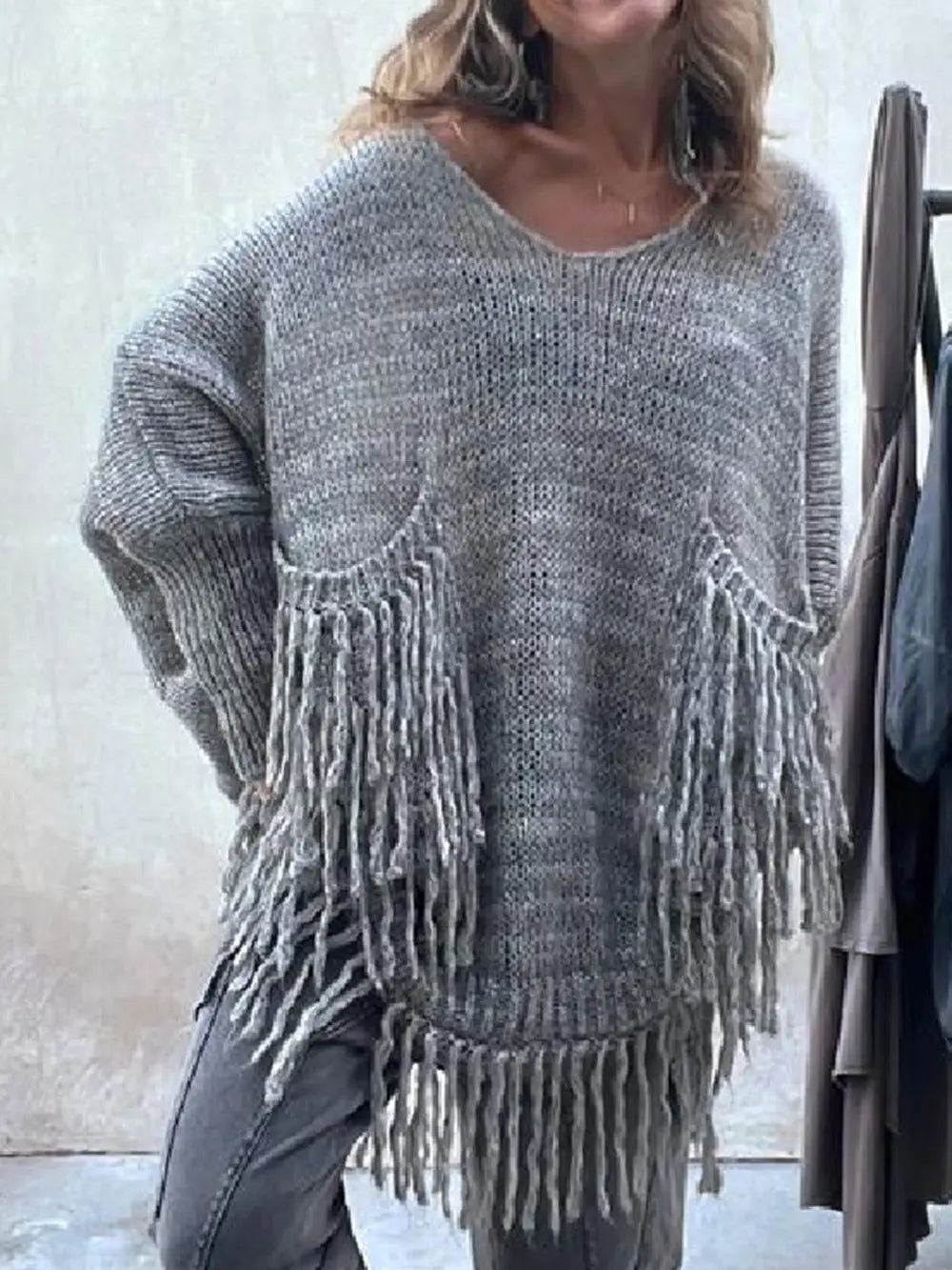 Dark gray long-sleeve sweater with fringe pocket detail and scoop neckline.