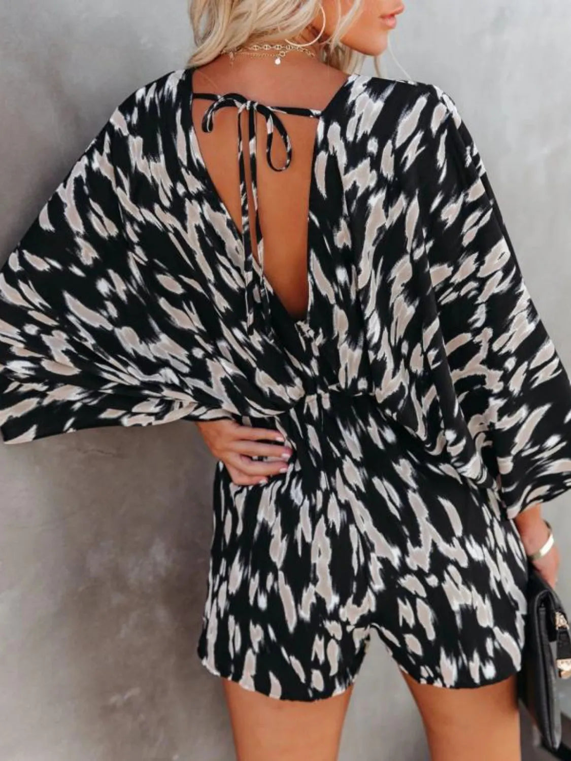 Black-and-white leopard print romper with open tie-back V-neck and kimono sleeves
