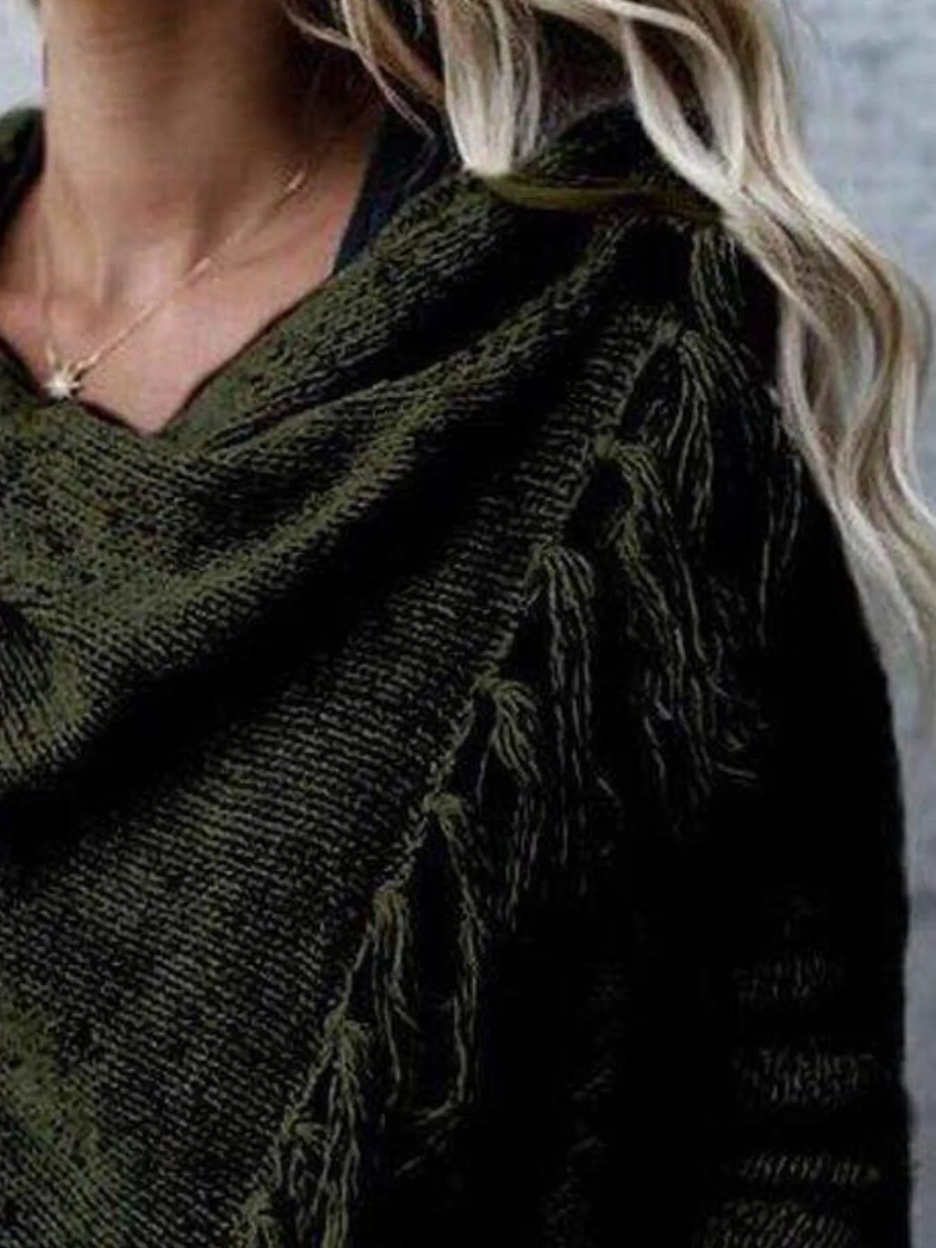 Dark green wrap cardigan close-up with cowl neck and fringe shoulder detail