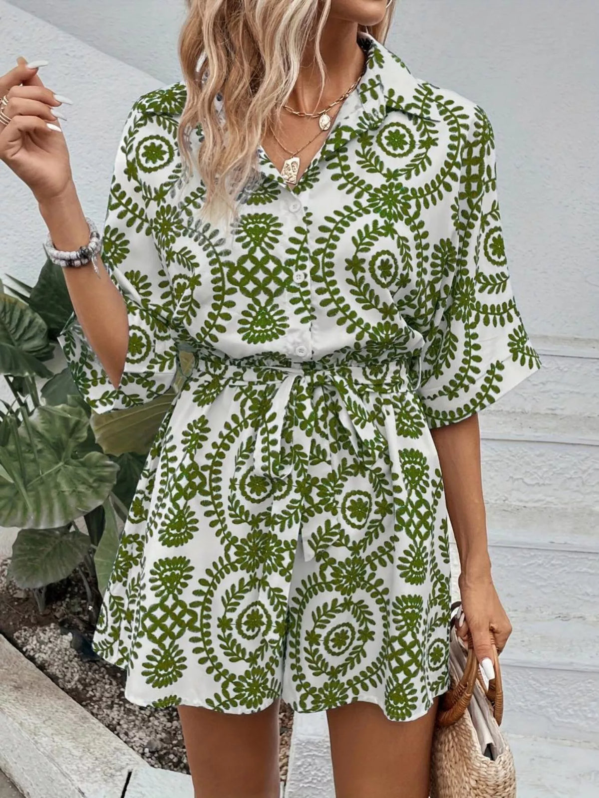 Green printed tie-waist button-front romper with flared short sleeves and tiered hem