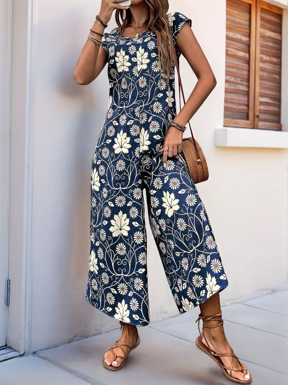 Navy printed wide-leg jumpsuit with round neck and cap sleeves, flowy culotte length