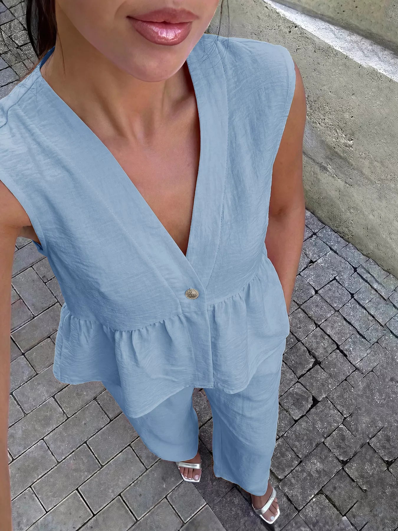 Light blue peplum V-neck sleeveless top and wide-leg pants set, button front