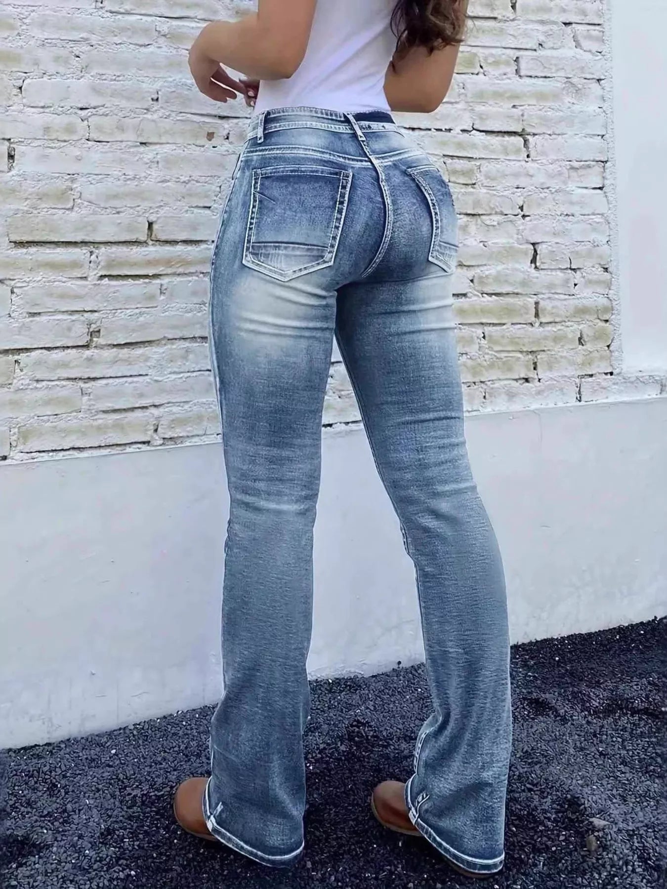 High-waist bootcut jeans shown from back with rear yoke and back pockets