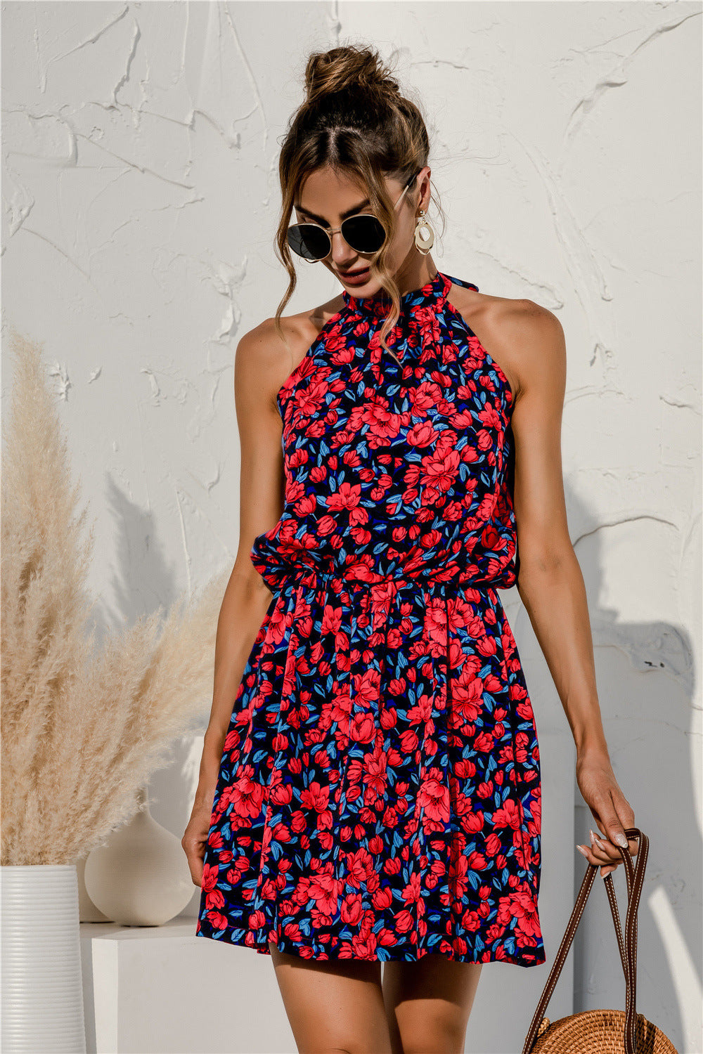 Red floral sleeveless mini dress with halter neckline and smocked waist seam