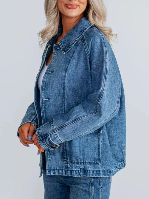 Blue denim jacket with button placket, chest pockets, and raglan-style shoulders