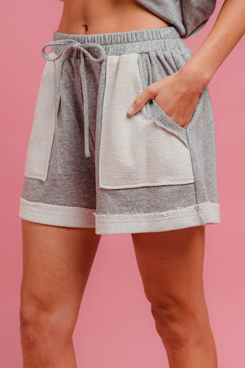 Heather grey knit shorts with elastic waist, drawstring tie, and side pockets
