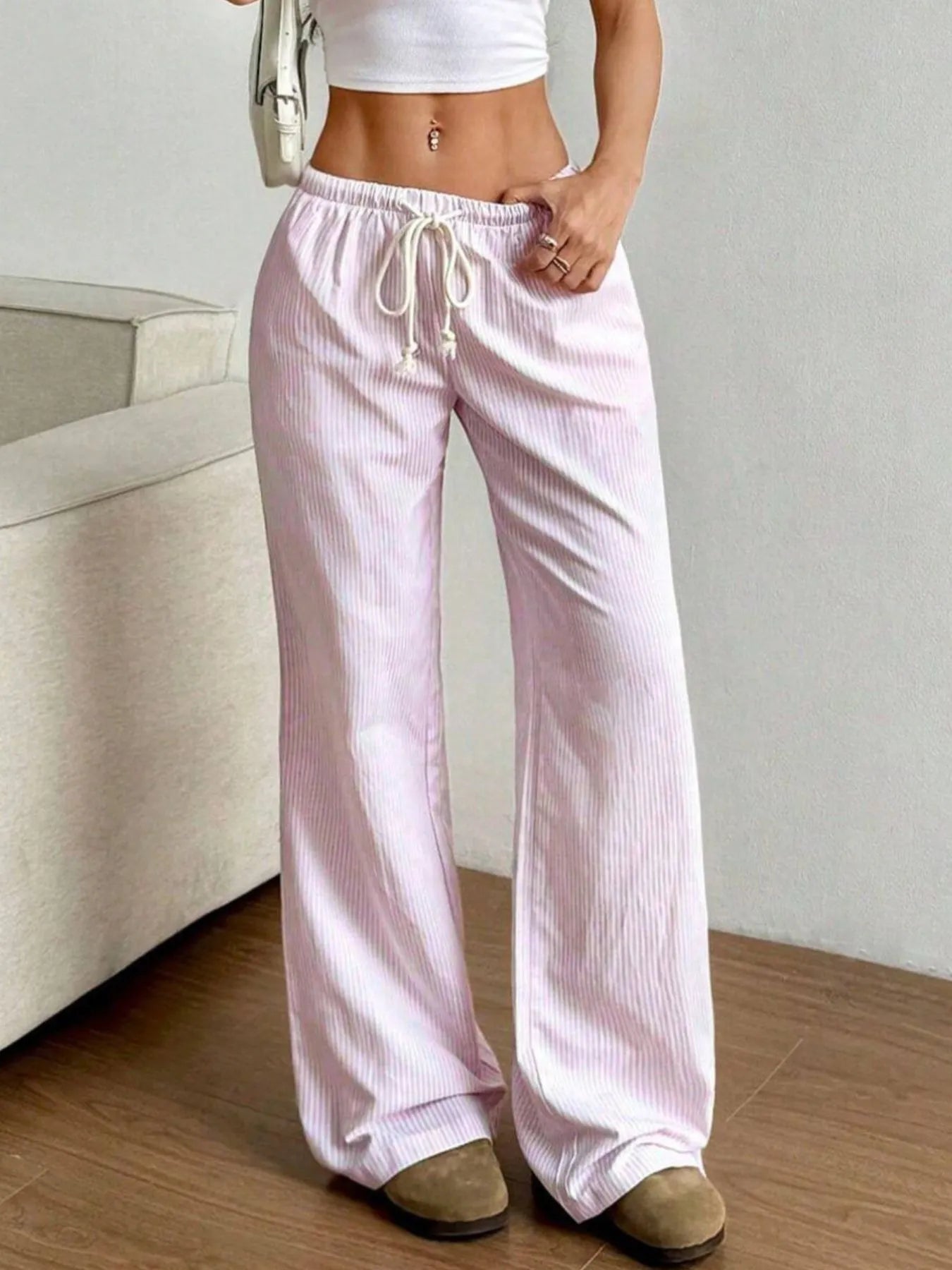 Light pink striped wide-leg pants with elastic drawstring waist and tassel cords