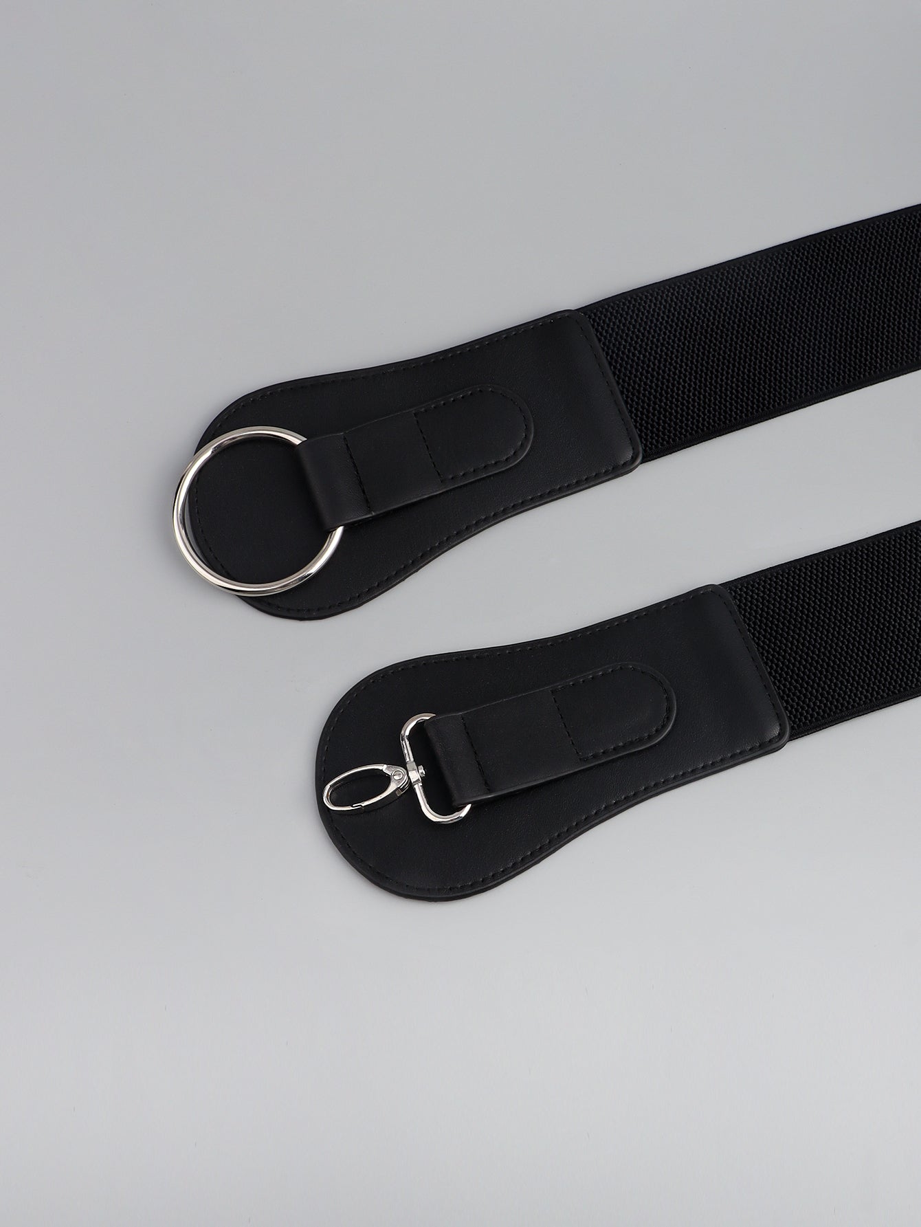 Black wide elastic belt with silver O-ring and buckle, shown from two angles