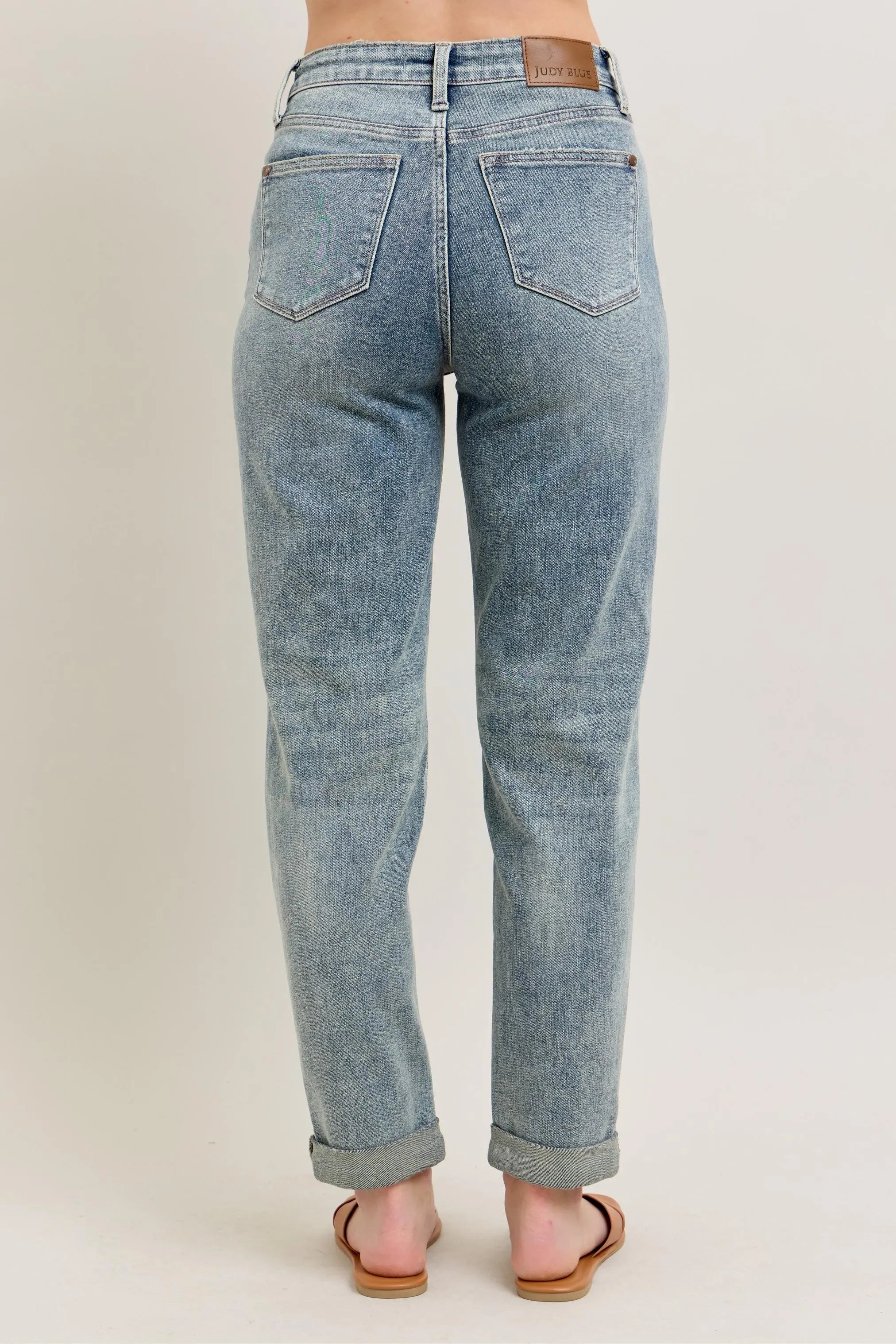 Light blue vintage-wash jeans with back pockets and double roll cuff